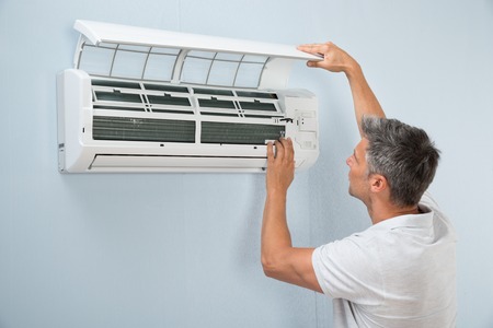 39430622 - portrait of a man cleaning air conditioning system
